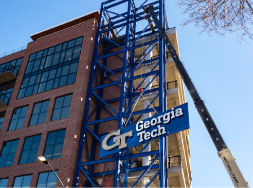 crane holding the georgia tech logo at a construction site