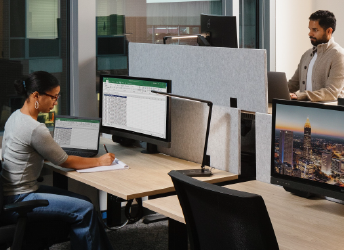 2 staff members working in a flex space on campus